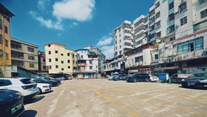 A street view with multiple parked cars and buildings. - City Comfort Inn (Guangzhou)