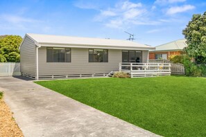 A single-story house with a front porch, a small yard, and a clear sky. - Shell Shack (Apollo Bay)