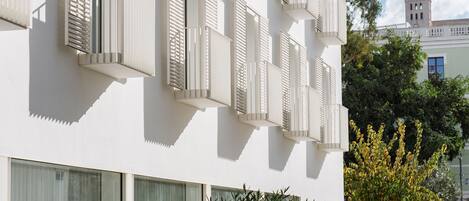 A modern building with multiple balconies and large windows.
