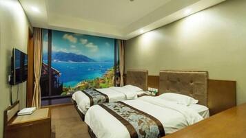 A hotel room with two beds, a TV, and a large window with a scenic view.