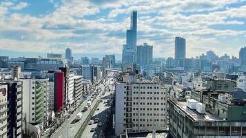 A cityscape with a prominent skyscraper, busy streets, and various buildings.