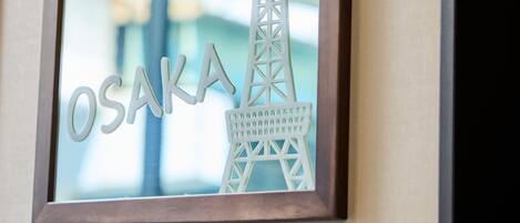 A framed cutout of a tower with the word 'OSAKA' beside it.