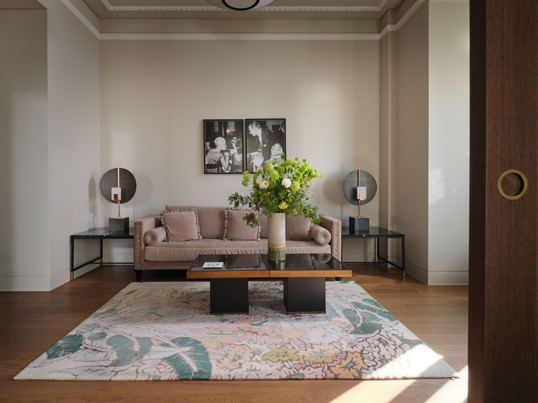 A living room with a sofa, coffee table, and decorative vases.