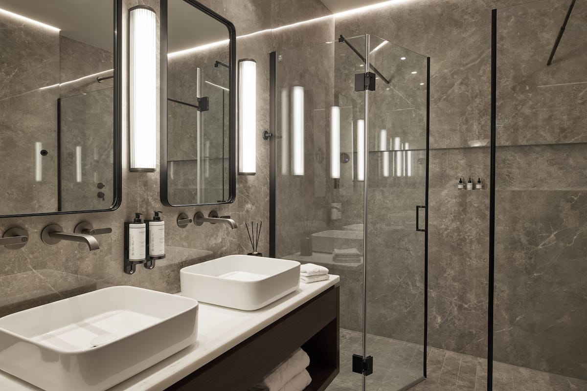 mediterranee suite sea front balcony | bathroom | rainfall showerhead, eco-friendly toiletries, bathrobes, slippers