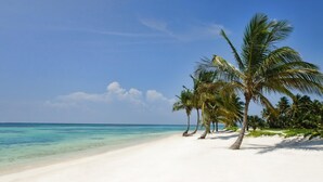 A beach with white sand and clear turquoise water. - One-of-a-kind Villa With Open Spaces and Amazing Views in Luxury Beach Resort (Punta Cana)