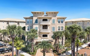 A multi-story building with a symmetrical facade, multiple balconies, and a central entrance. - New Rental in Seacrest Beach Resort, stunning views of Lagoon Pool, 3 bikes! (Panama City Beach)