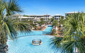 A resort with a central swimming pool, multiple buildings, and palm trees. - New Rental in Seacrest Beach Resort, stunning views of Lagoon Pool, 3 bikes! (Panama City Beach)