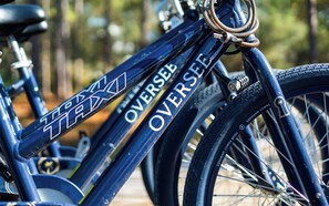A close-up of a bicycle with the text "OVERSEER" and "OVERSEER" on the frame. - New Rental in Seacrest Beach Resort, stunning views of Lagoon Pool, 3 bikes! (Panama City Beach)