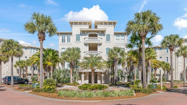 A large, multi-story hotel with a symmetrical facade, featuring balconies and a central entrance.