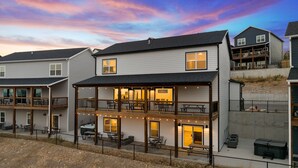 A two-story building with a balcony and outdoor seating area, featuring a sign that reads "The Village."