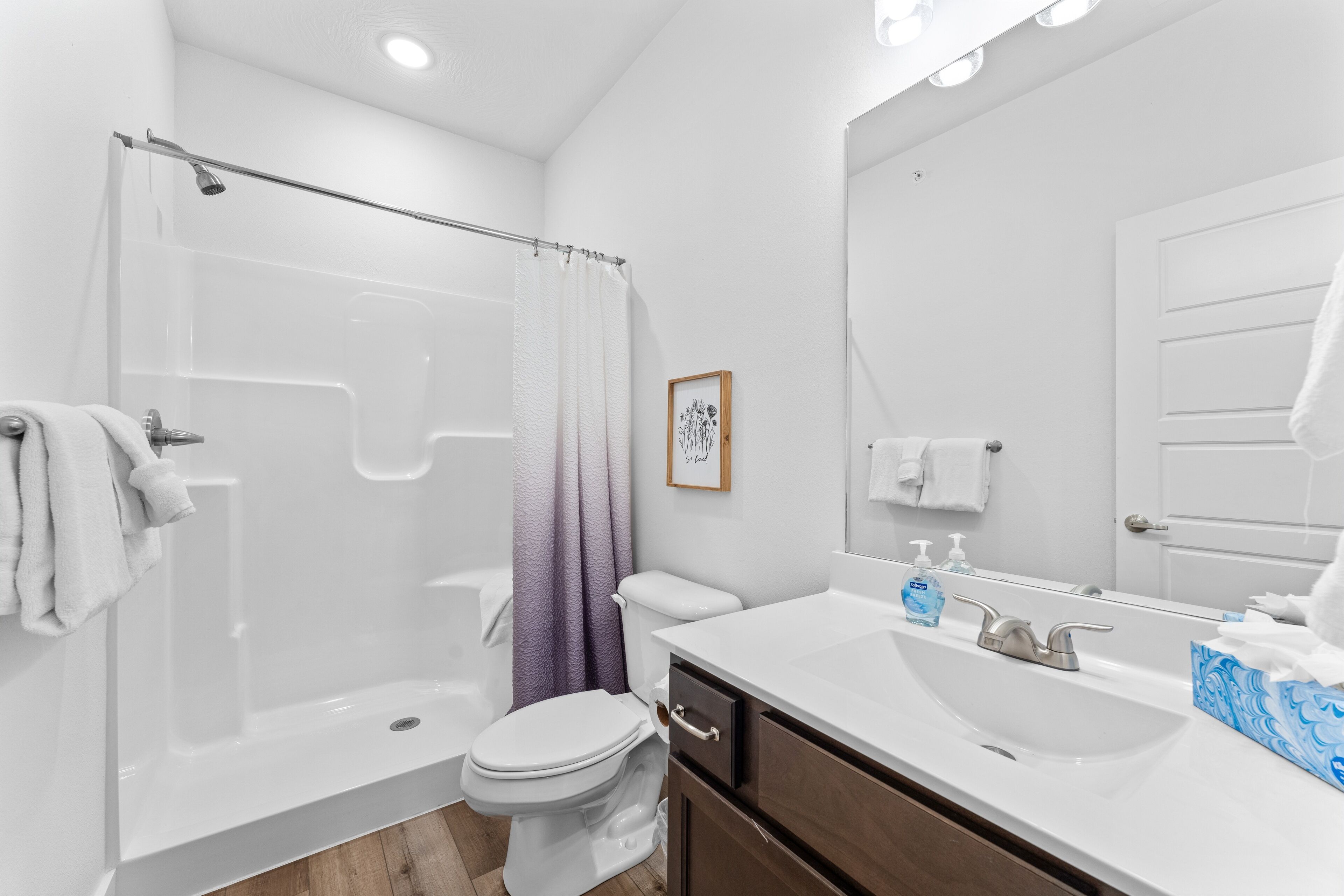 A modern bathroom with a bathtub, toilet, and sink.