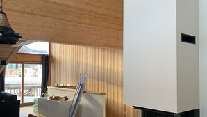 Um interior moderno com área de refeições, lareira e vista para o exterior.