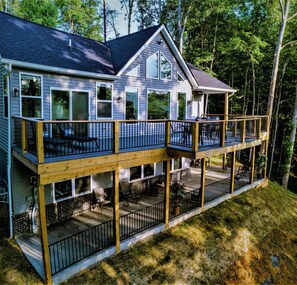 A two-story house with a balcony and deck, surrounded by trees. - 🌞The Abundant Life on Lakeshore🌞 - Lakeview Home <1/4 Mile to Public Boat Ramp (Nancy)