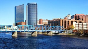 A bridge with blue railings over a river, with buildings in the background. - Spacious double unit near shops (Rockford)