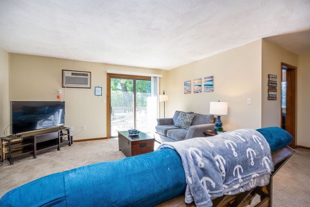 A living room with a TV, sofa, and a coffee table.