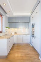 Standard Apartment | Private kitchen | Electric kettle, toaster, cookware/dishes/utensils, dining tables