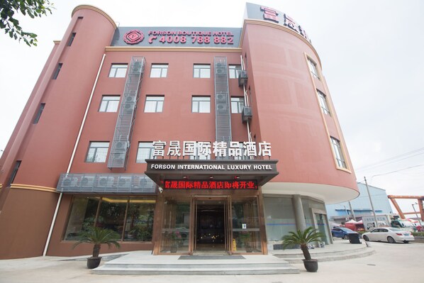 A hotel with a prominent sign for the Forson International Luxury Hotel.