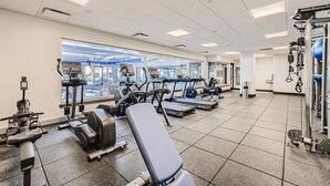 A gym with treadmills, elliptical machines, and weightlifting equipment. - Downtown Breck Ski In Ski Out! Walk to Everything (Breckenridge)