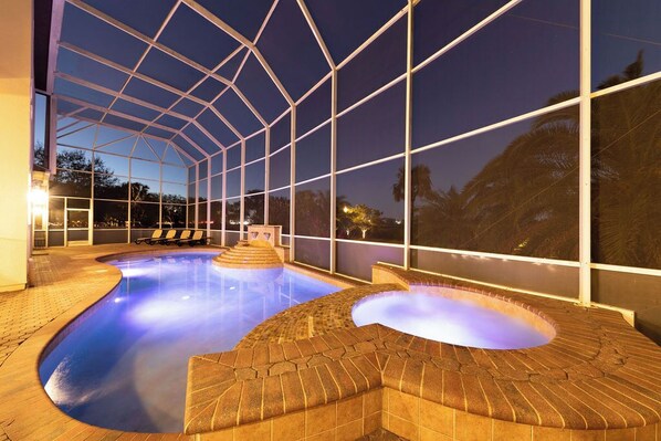 Swim and unwind in our pool area, surrounded by a patio and offering a view of the surrounding landscape.
