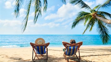 On the beach, sun loungers, beach towels