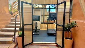 A gym with exercise equipment, a treadmill, and a stationary bike. - Stylish Beachside. Parking.Views. FrontofBdg. (San Pedro)