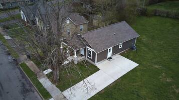 A two-story house with a front yard and a driveway.