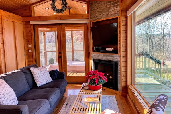 Tiny is a cozy place flooded with light and warmed by a custom fireplace.