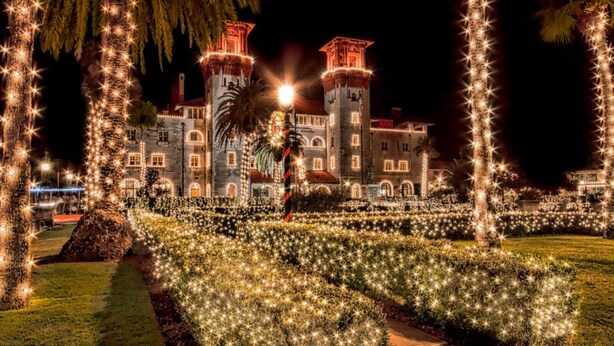 A historic building with a tower, surrounded by a garden with string lights. - Just Beachy: Stunning 4BR Oceanfront Home + Private Pool (St. Augustine)