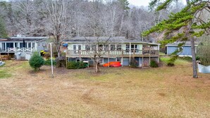 A two-story house with a fenced yard, a covered porch, and a small shed. - Spacious Lake House Retreat! (Westminster)