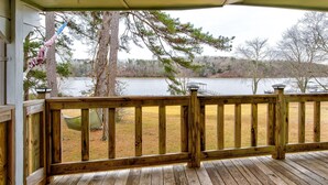 A wooden deck with a view of a lake and trees. - Spacious Lake House Retreat! (Westminster)