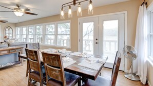 A dining area with a wooden table, chairs, and a ceiling fan. - Spacious Lake House Retreat! (Westminster)