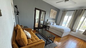 A modern bedroom with a bed, a sofa, a desk, and a world map on the wall. - RelaxBeachPad Beachside Studio!Parking&Laundry (San Pedro)