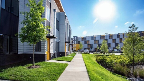 A modern apartment complex with numbered buildings, a well-maintained lawn, and a clear sky. - Urban Oasis Spacious King Bed Free Parking (Nashville)