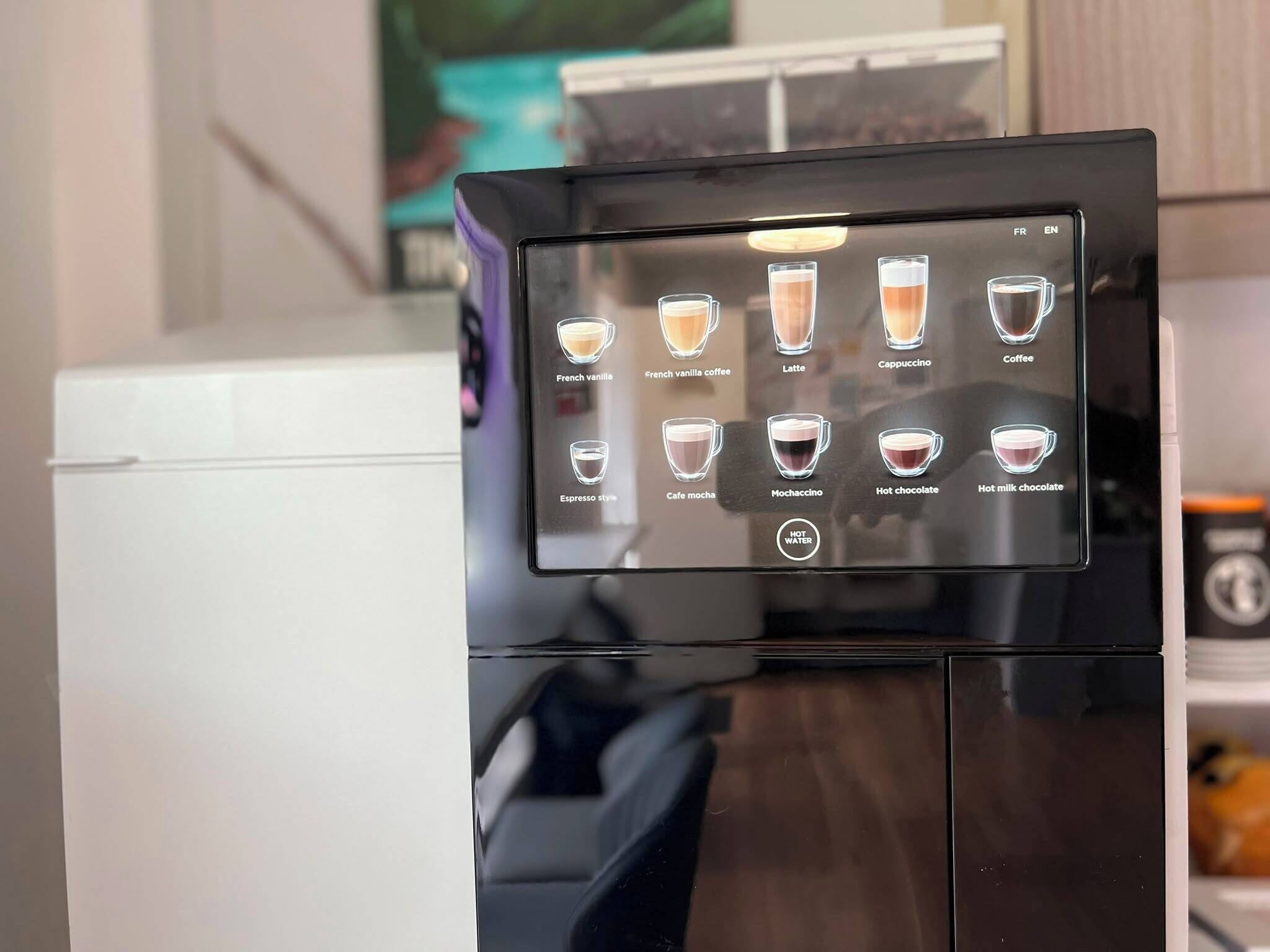 A coffee machine with a digital display showing various coffee options.