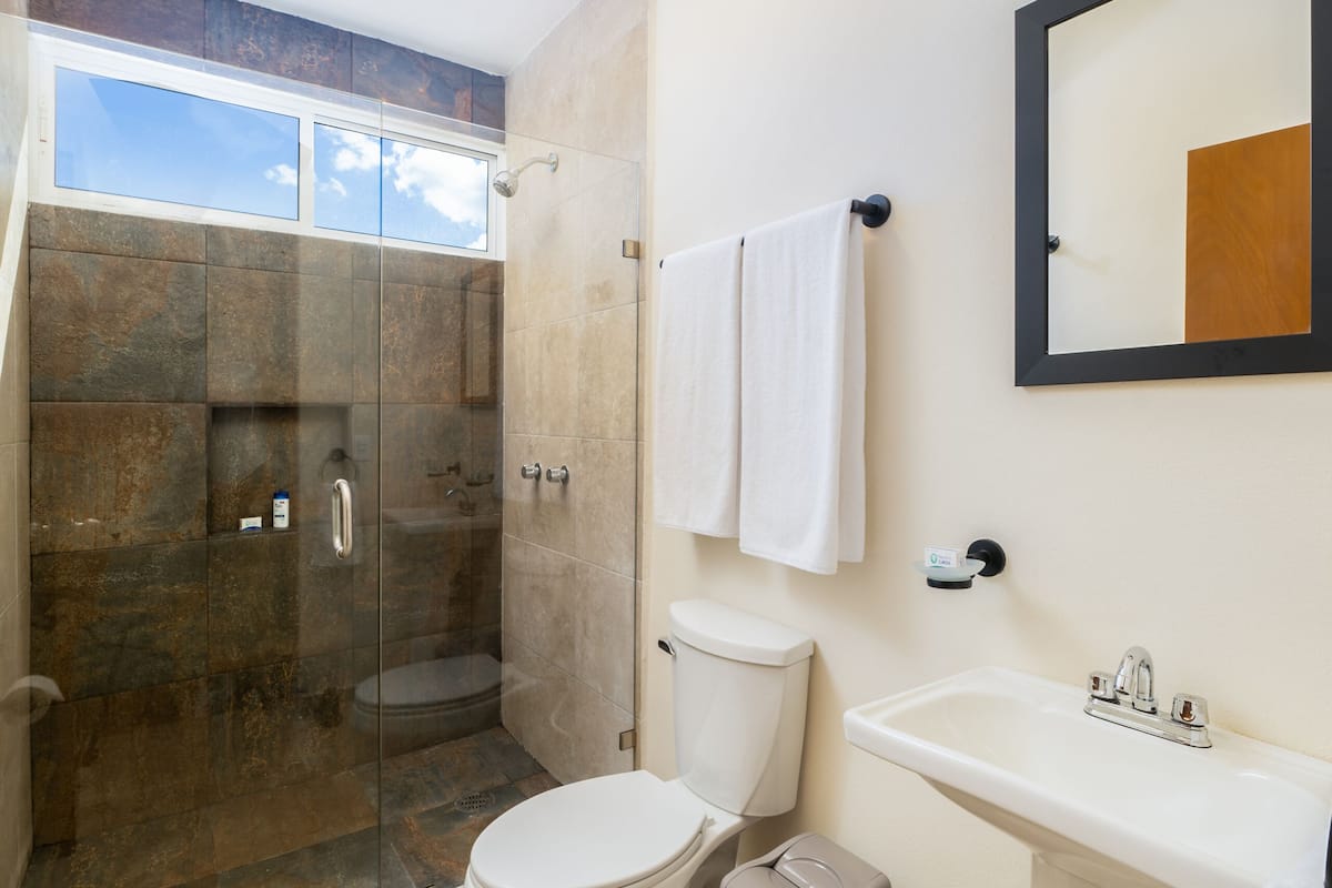 junior room | bathroom | shower, rainfall showerhead, hair dryer, towels