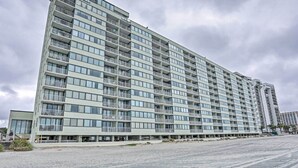 A multi-story hotel with balconies, a flat facade, and a paved ground floor. - Ocean Views & Pool Access: Myrtle Beach Condo! (Myrtle Beach)
