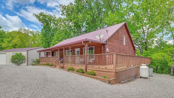 Cozy cabin with a rustic charm, featuring a wooden porch and satellite TV access.