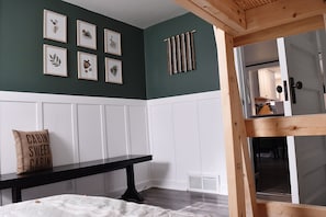Cozy retreat with a cabin-inspired aesthetic, featuring a wooden beam structure and a comfortable bench.