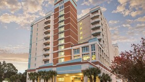 A multi-story hotel with a modern architectural design, featuring balconies and a prominent entrance. - 1BR Horizons Condo On Beautiful Myrtle Beach Resort w/Amenities (Myrtle Beach)