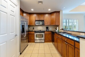 Enjoy cooking in this well-equipped kitchen with a refrigerator, microwave, and oven.