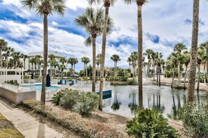 A resort with a pool, palm trees, and a water feature. - 300 Feet from the Beach, Steps to the Seasonally Heated Pool - Cabana 111 at Gulf Place on 30A (Santa Rosa Beach)