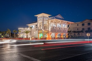 A multi-story hotel with a prominent tower and balcony, featuring a modern architectural design. - 300 Feet from the Beach, Steps to the Seasonally Heated Pool - Cabana 111 at Gulf Place on 30A (Santa Rosa Beach)
