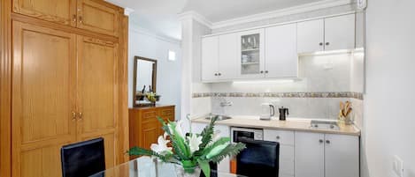 Fridge, microwave, stovetop, coffee/tea maker