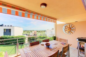 Enjoy al fresco dining with a view of the beautifully maintained garden and neighboring buildings.