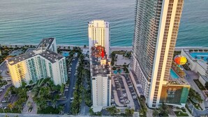 A high-rise hotel with multiple floors, a swimming pool, and a view of the ocean. - Great apartment in Hollywood with side ocean view! Direct exit to the beach! (Hollywood)