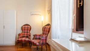 A room with two plaid armchairs, a white cabinet, and a window with a curtain. - Siracusa Horizon Home by Wonderful Italy (Siracusa)