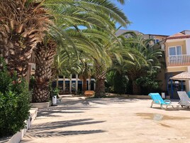 Seasonal outdoor pool, open 8:00 AM to 6:00 PM, pool umbrellas