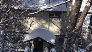A snow-covered pathway leading to a building with a covered entrance. - Serene View Chalet | Hot Tub - King Beds Mtn Views (Big Bear Lake)