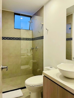 Shower, hair dryer, towels, shampoo