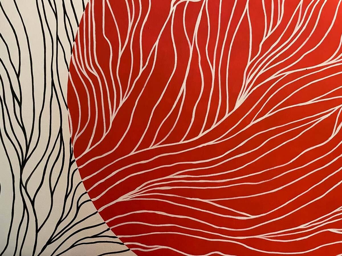 Quarto com padrão listrado em vermelho e branco na parede.